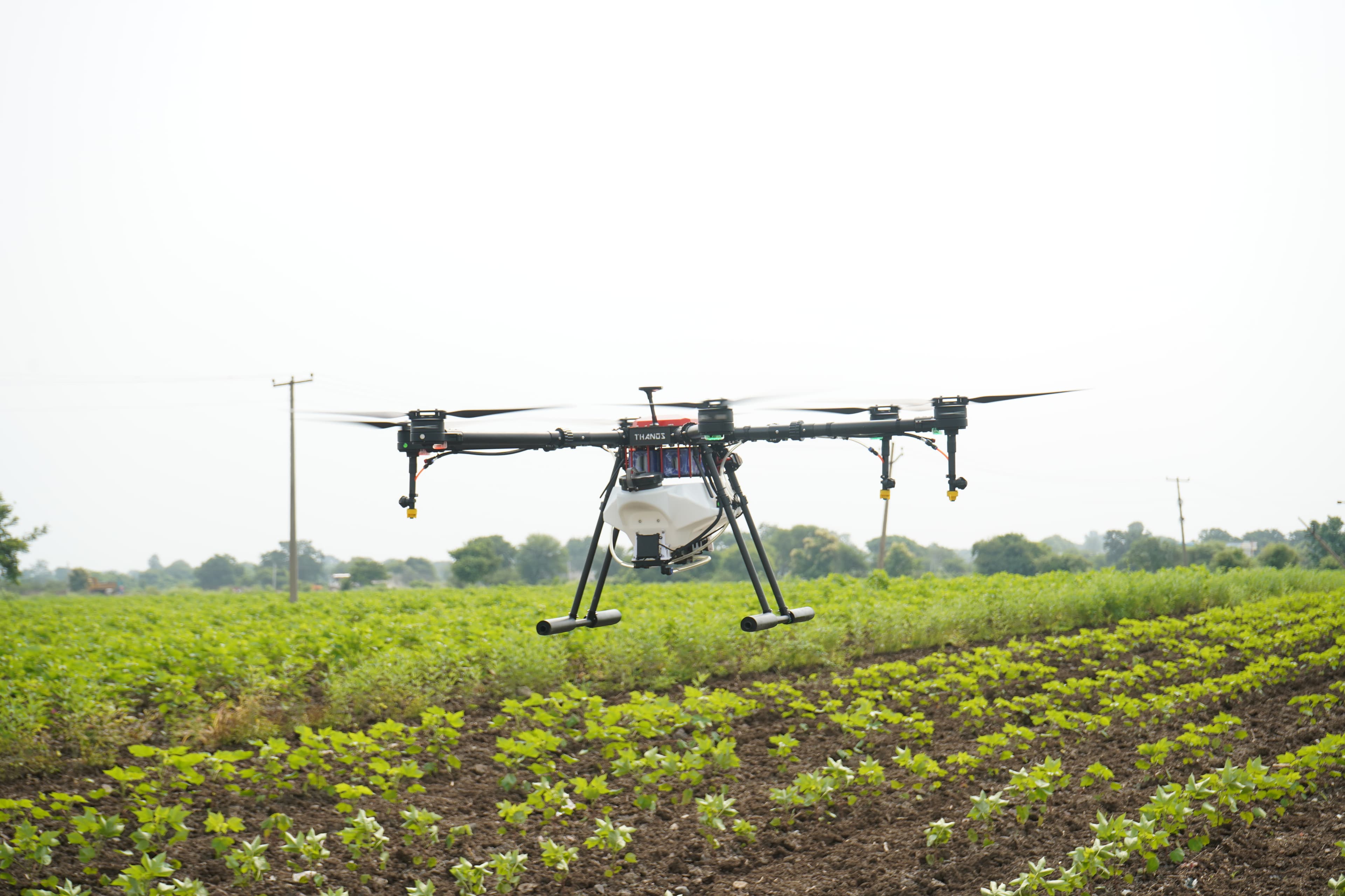 Drone operating over a green farm field